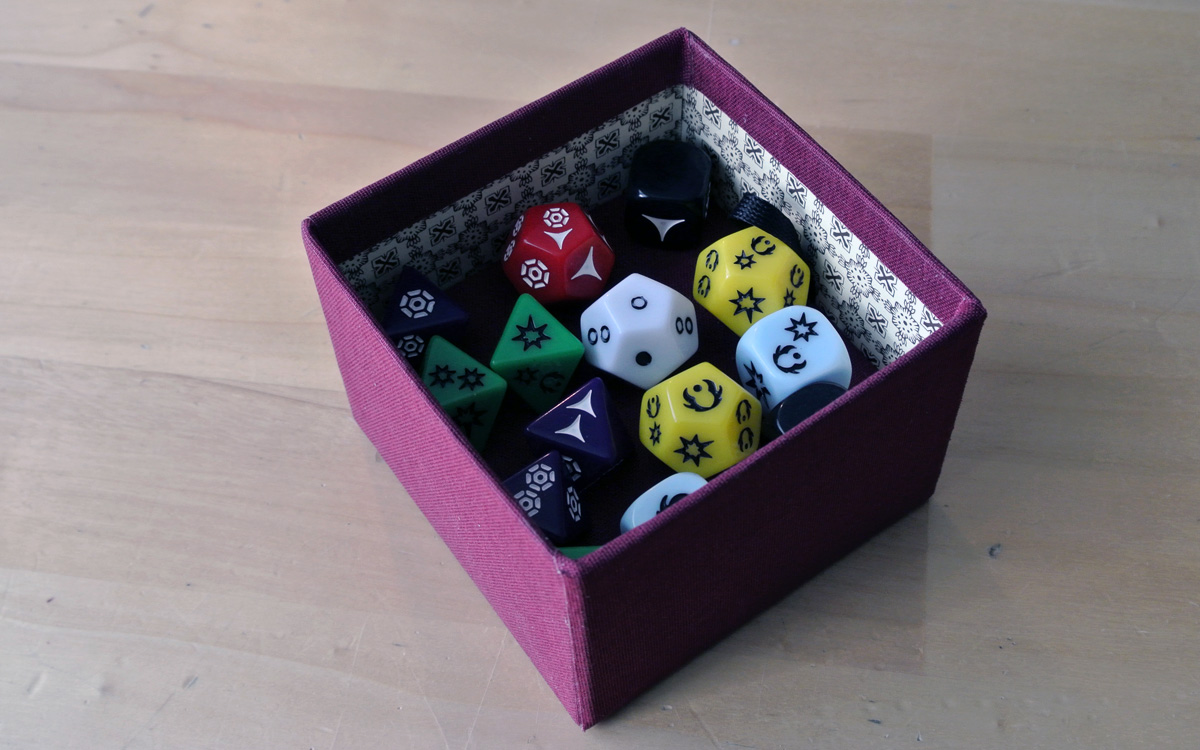 The first layer in the box, with the speciality dice.