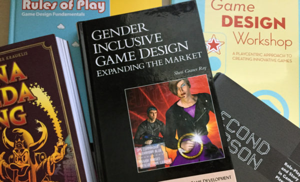 a photograph of several books about game design